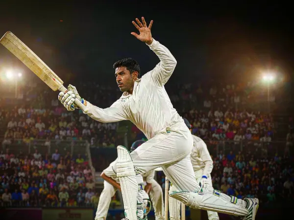 six6s + Cricketer in white playing a shot under floodlights in a packed stadium