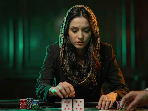 six6s + Woman concentrating on two face-up cards at a blackjack table