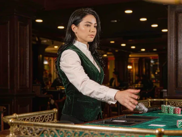 six6s + Dealer revealing cards at a baccarat table with neat chip stacks